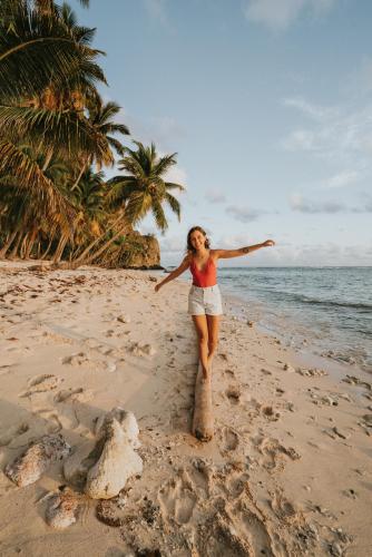 a woman is standing on the beach at El Valle Lodge in El Valle
