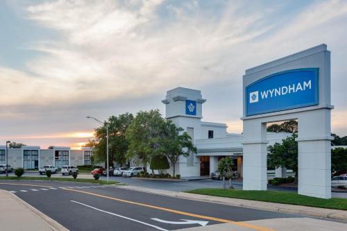 a building with a sign on the side of a road at Wyndham Riverfront Hotel in Little Rock