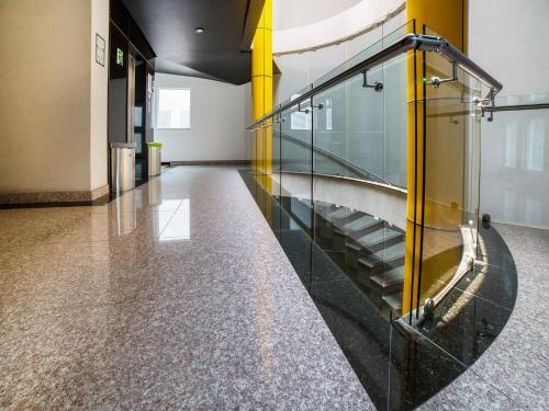 a hallway with a glass staircase in a building at Hotel Via La Villa in Mexico City