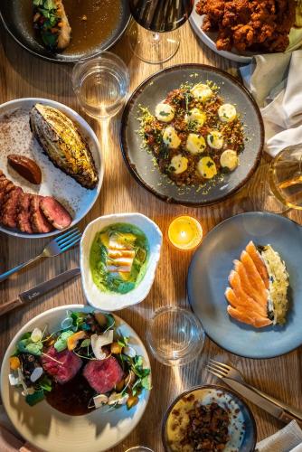 a table with plates of food on it at MADE Hotel in New York