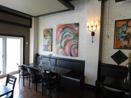 a dining room with a table and chairs at The Gould Hotel in Seneca Falls