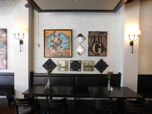 a dining room with a table and chairs at The Gould Hotel in Seneca Falls