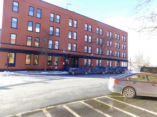 a red building with cars parked in front of it at The Gould Hotel in Seneca Falls