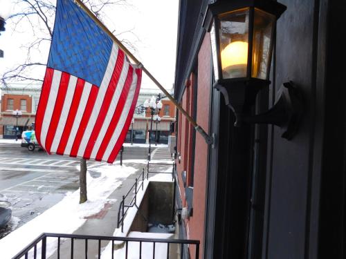 an american flag hanging on the side of a building at The Gould Hotel in Seneca Falls