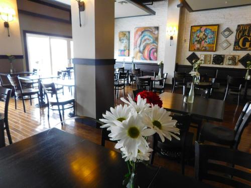 a vase of flowers sitting on a table in a restaurant at The Gould Hotel in Seneca Falls
