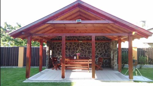 a wooden gazebo with a table in a yard at Chalupa Liptovský Mikuláš in Liptovský Mikuláš