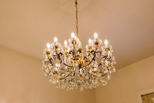 a chandelier hanging from a ceiling at Exclusive Aparthotel La Reunion in Ravenna