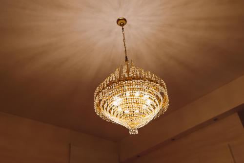 a large chandelier hanging from a ceiling at Exclusive Aparthotel La Reunion in Ravenna