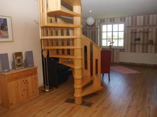 escalera de caracol de madera en la sala de estar en Ferienwohnung Weserblick Polle, en Polle