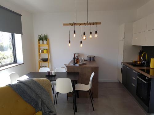 a kitchen and dining room with a table and chairs at Holiday home Velebit in Nin