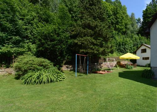 a garden with a soccer goal in the grass at Penzion U Rodinky in Bělá pod Pradědem