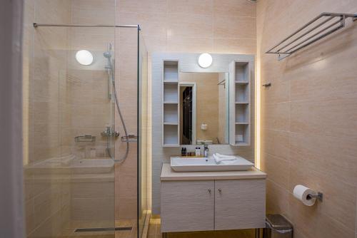 a bathroom with a shower and a sink and a shower at Ammos Sea Front Rooms - Adults only in Vasilikos