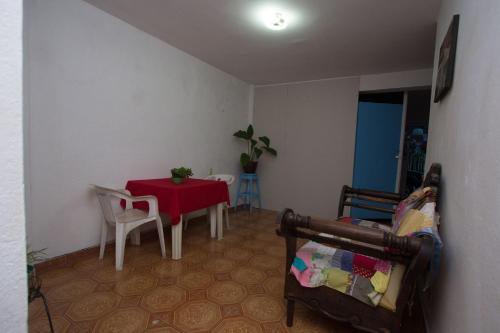 a living room with a red table and chairs at Las Huellas del Caminante in Catemaco