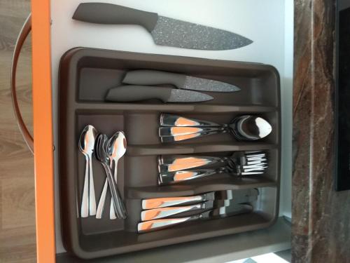 a drawer full of utensils in a box at Apartmán ALEX in Poprad