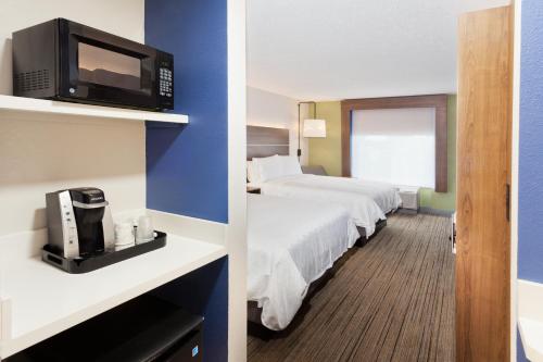 a hotel room with two beds and a microwave at Holiday Inn Express Hotel & Suites Dothan North by IHG in Dothan