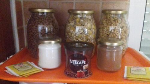 a shelf with jars of nuts and other food items at Potokia Rooms in Kakóvatos