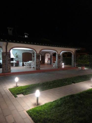 a house with lights in the yard at night at Casa Mari in Principina Terra