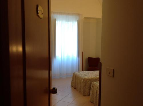 a bedroom with a bed and a window at Hotel Castello in Mesagne