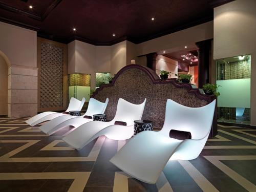 a row of white chairs in a lobby at Hard Rock Hotel Riviera Maya - Heaven Adults Only - All Inclusive in Puerto Aventuras