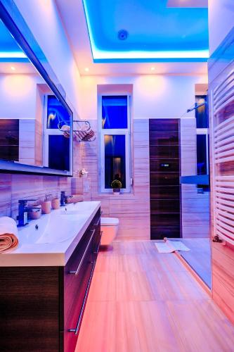 a bathroom with a sink and a toilet and a tub at Luxury Smart Apartments in Szeged