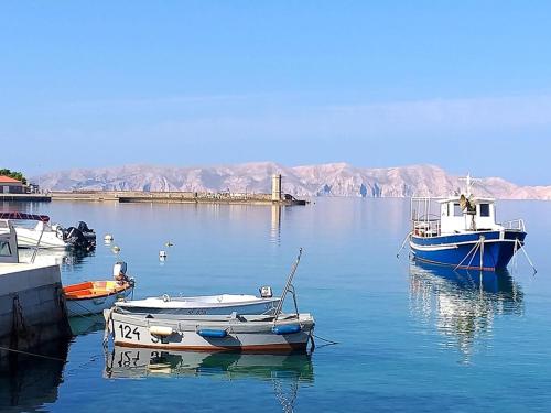 three boats are docked in a body of water at Josipa & Jelena Apartment in Senj