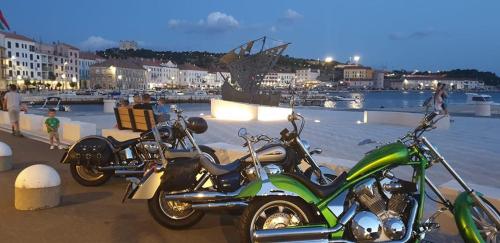 a couple of motorcycles parked next to the water at Josipa & Jelena Apartment in Senj