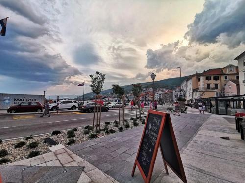 a street with a sign on the side of the road at Josipa & Jelena Apartment in Senj