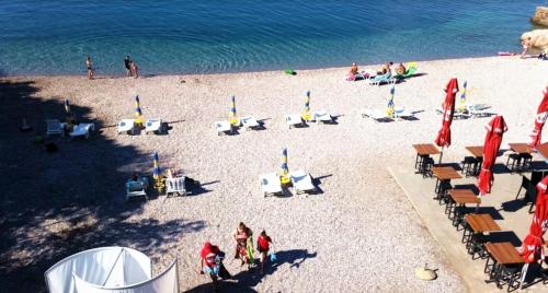 an overhead view of a beach with chairs and people at Josipa & Jelena Apartment in Senj