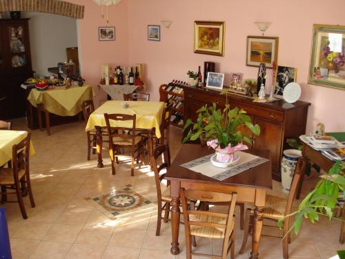 a dining room with tables and chairs and a table at Agriturismo Ai Piacentini in Santo Stefano Belbo