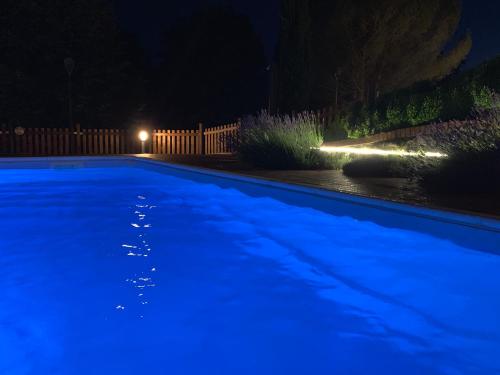 a swimming pool at night with blue illumination at Agriturismo Pratofranco in Pontremoli