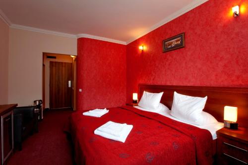 a red bedroom with a bed with red walls at Relax Inn in Prague