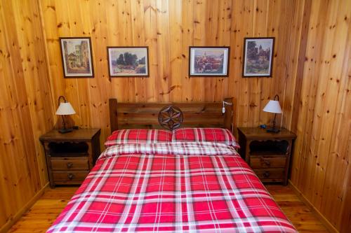 a bedroom with a bed with a red and white blanket at A casa di Martina - CIR 0051 in Aosta