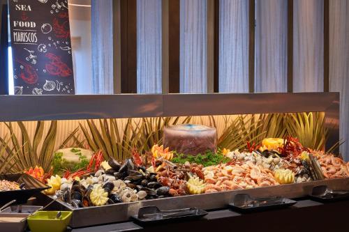 a buffet of different types of food on a table at Palace Bonanza Playa Resort & SPA by Olivia Hotels Collection in Illetas