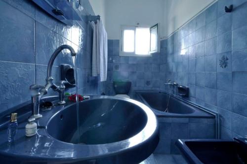 a bathroom with a large tub and a sink at Anastasios Paleokastritsa apartment in Doukádes