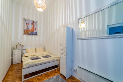 a small bedroom with a small bed in it at Gabi's Central Broadway Nest @ Nagymező str in Budapest