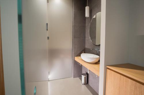 a bathroom with a white sink and a mirror at Chill in Tuscany in Lucca