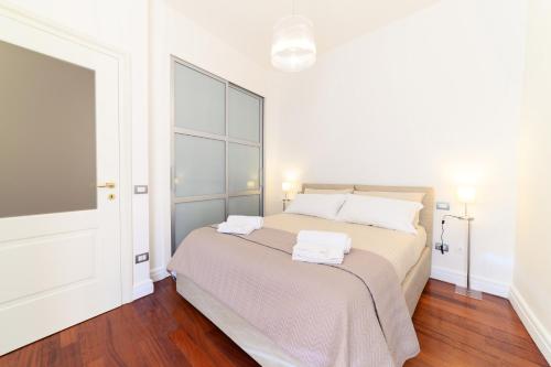 a bedroom with a bed with two towels on it at Glam House Apartment in Salerno