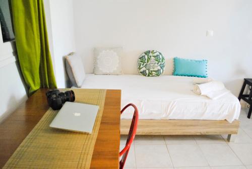 a room with a bed with a laptop on a table at Kykeon Studios in Katelios