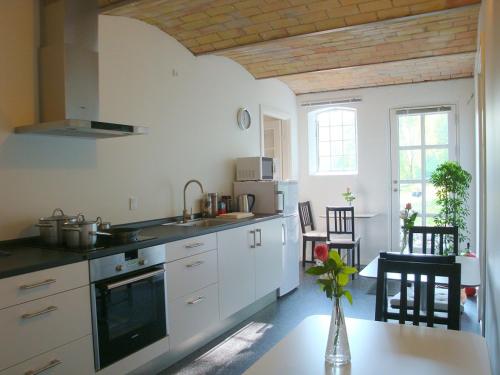 a kitchen with a sink and a stove top oven at Engelsholm Bed & Breakfast in Bredsten