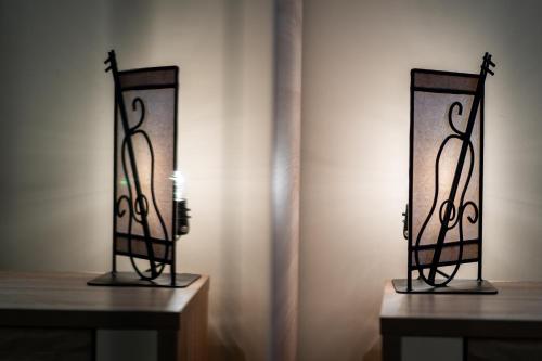 a couple of mirrors sitting on two wooden tables at Apartman Vasilisa Kalman in Zlatibor