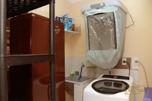 a small bathroom with a toilet with a plastic over it at Casa Boutique Bèla Sofía in Asuncion