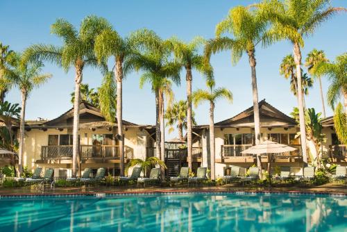 a resort with palm trees and a swimming pool at Humphreys Half Moon Inn in San Diego
