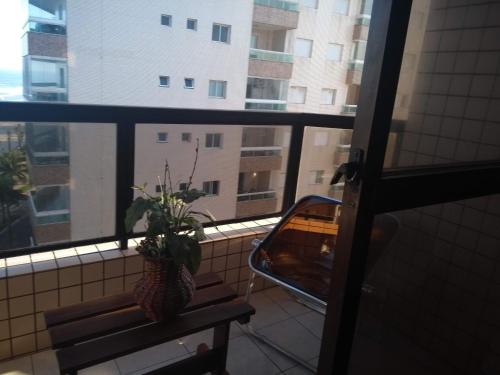 a view of a balcony with a bench and a window at apto de frente ao mar in Praia Grande