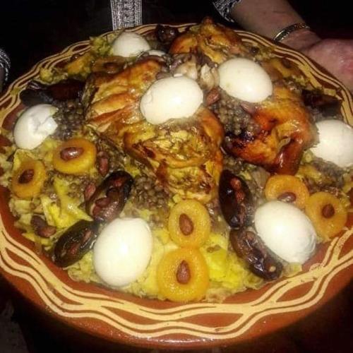a plate of food with seafood and other foods at Le petit Jardin in Demnat