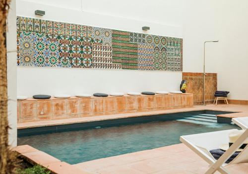 a swimming pool in a room with a wall at Santa Paula Pool & Luxury in Seville