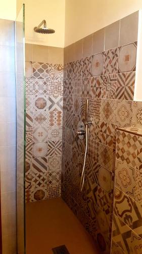 a bathroom with a shower with a glass door at La Cappuccina in Corniglio