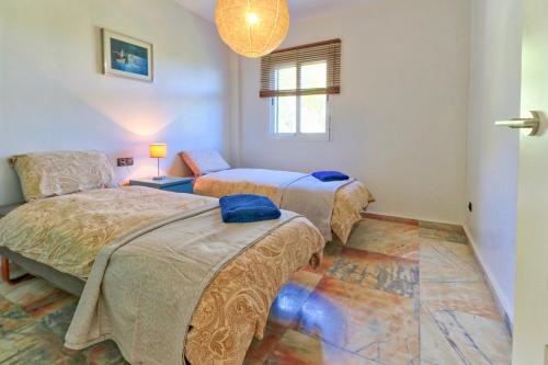 a bedroom with two beds and a window at Penthouse Reserva del Higueron in Benalmádena