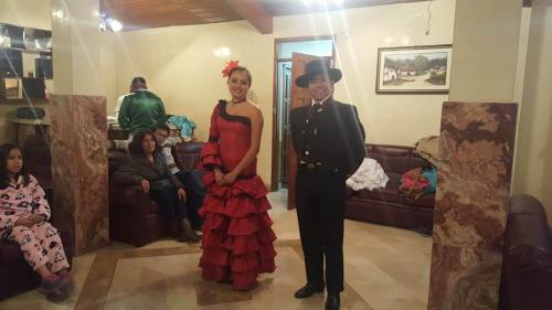a man and a woman standing in a living room at Casa de Mármol in Riobamba
