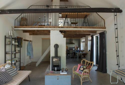 a living room with a loft bed and a living room at Harrys Hardware Home in Brösarp