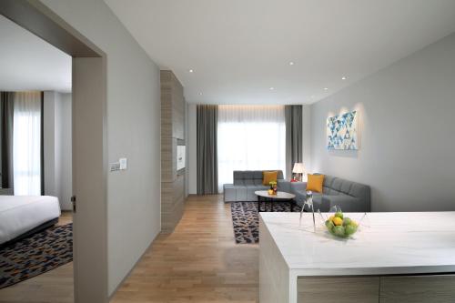a living room with a couch and a table at Capri by Fraser Johor Bahru in Johor Bahru